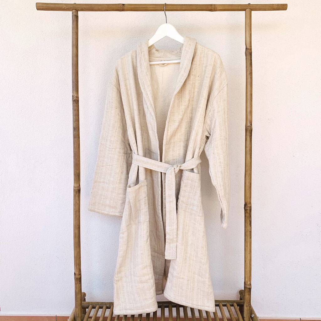 Hygge Luxe Bathrobe hanging from a wooden rack