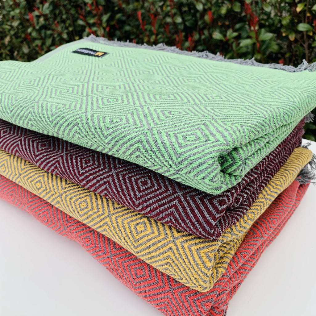 Folded Carré blankets in various colors