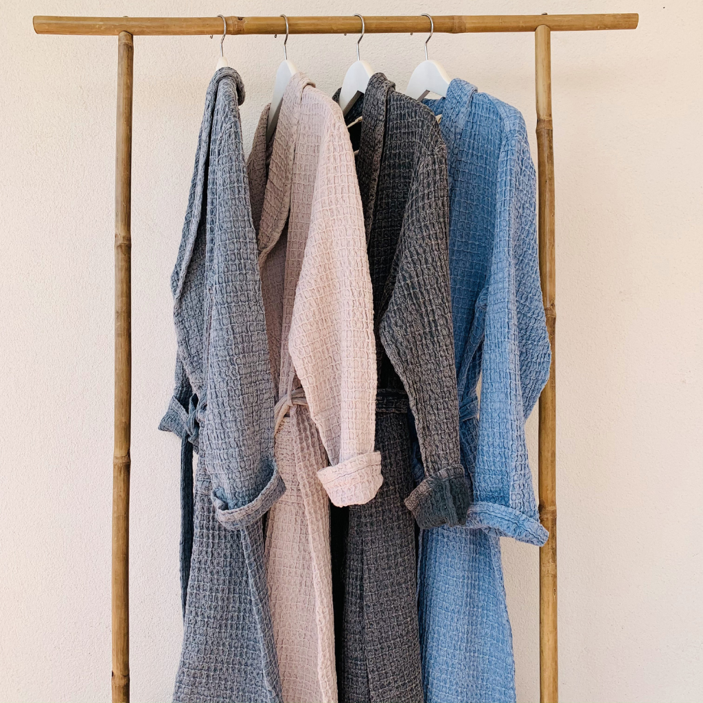 Stroopwafel Bathrobes in various colors hanging from a rack